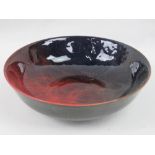 A Royal Doulton Sung flambe circular bowl with mottled red to blue glaze, 18cm diameter.