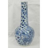 A Chinese blue and white bottle vase hand painted with dragons amid profuse foliage and flower
