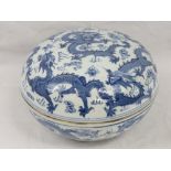 A 20thC Chinese blue and white circular bowl and cover, decorated with dragons and flaming pearls,