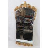 A bevel edge waisted hanging wall mirror having pierced and gilded decoration upper and lower,