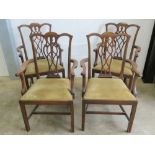 A set of four mahogany country Chippendale open armchairs each with velvet drop in seats.