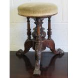 A Victorian mahogany revolving rise and fall circular piano stool,