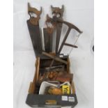A quantity of vintage tools including; tenon saws, auger, hand drill, flat head screwdrivers, etc.