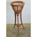 An Edwardian open torchere planter stand having three outswept legs (one a/f),