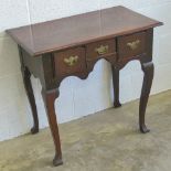 A good country made late Georgian lowboy having central drawer flanked by twin box drawers,