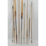 Two 20th century tribal spears, each having steel blade mounted on long wooden shafts,