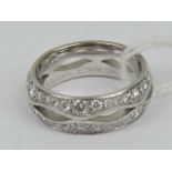 An 18ct white gold ring having central 'cut out' marquise shaped segments flanked to the front by