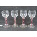 A quantity of four decorative air twist stem glasses each standing 17cm high.