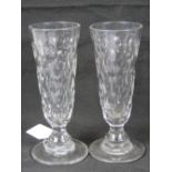 A fine pair of faceted glasses each having large foot and pontil marked base,