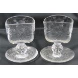 A pair of unusual clear glass waifer holders raised over bubble stem and cup foot,