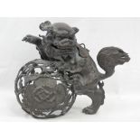 A good and heavy 19th century Chinese bronze censer cover in the form of a Fo dog raised over a