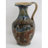 A Doulton Lambeth stoneware jug with incised lappets and oak leaves in brown and blue glazes,