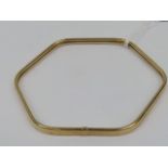 An unusual 9ct gold hexagonal bangle, hallmarked 375, being 7-7.5cm dia and weighing 4.5g.