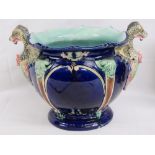 A Majolica jardiniere planter having dragons head handles in blue ground and standing 26cm high.