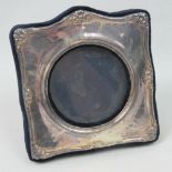 A HM silver photograph frame having circular glazed panel and velvet easel back,