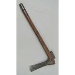 A tribal axe having wooden handle, naive steel blade, small amount of geometric pattern upon,