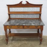 A fine Edwardian double washstand having twelve-tile shelved splash back over the marble base,