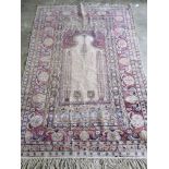 An antique woollen and silk Persian rug having central panel flanked by Geometric design around,