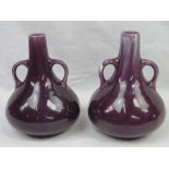 A composite pair of Linthorpe pottery style tapered two handled vases in mottled puce glaze,