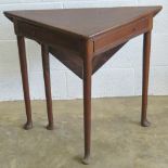 An unusual early 19th century country made oak extending cricket table having triangular lift up