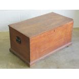 A Victorian mahogany lidded trunk having end handles, raised over plinth base,