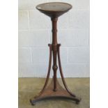 A late 19th century mahogany torchere stand raised over triform base, 102cm high.