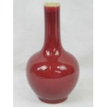 A Chinese sang de beouf bottle vase, drilled base, 23cm high.