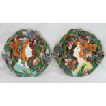 A pair of Art Nouveau style majolica relief moulded wall plaques of Pre-Raphaelite design of two