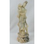 A single soapstone figuring of a standing Oriental maiden, 31cm high.