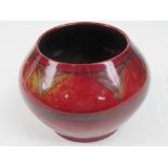 A Bernard Moore flambe circular squat vase with hand painted decoration, 9cm high, a/f.