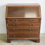 An Edwardian fall front bureau, lid lifting to reveal drawers and doors within,