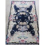 A small blue ground woollen rug with floral decoration upon, 155 x 93cm.