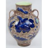 A 19thC French two handled vase signed L. Ernie, with underglaze blue and gilt floral decoration on