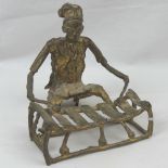 A good cast brass ethnic figurine of a seated xylophone player,