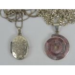 An oval floral locket on silver box link chain,