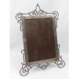A large HM silver photograph frame having scrolling decoration to top and bottom,