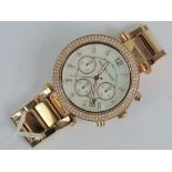 A rose metal Michael Kors watch having mother of pearl dial and three subsidiary dials,
