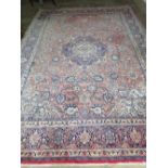 A good quality woollen and silk red and cream ground carpet with floral decoration upon,