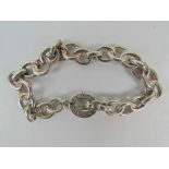 A HM silver Links of London charm bracelet having T-bar clasp and 'triple ring' panels joined by