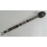 A 20th century African knobkerry having fur and bead decoration to the shaft, plain ball,