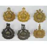 Six Royal Marines cap badges including; bandsman, bugler, trainee, etc.