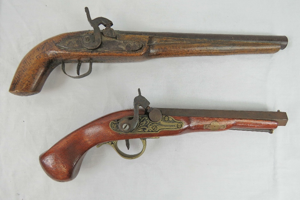 A pair of decorative hammer lock percussion cap and ball pistols.