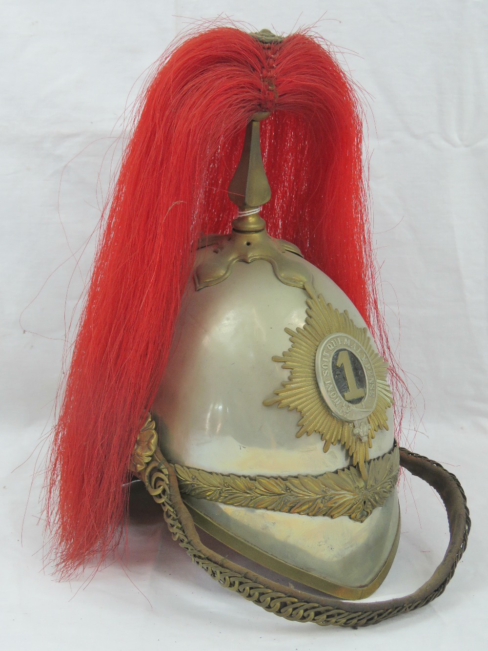 A Victorian Royal Dragoon Guards helmet bearing the number 1 to the shako plate,