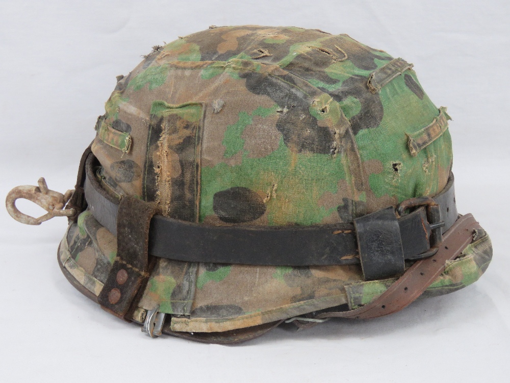 A WWII German M35 Infantry helmet with Dot camo cover,