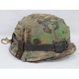 A WWII German M35 Infantry helmet with Dot camo cover,