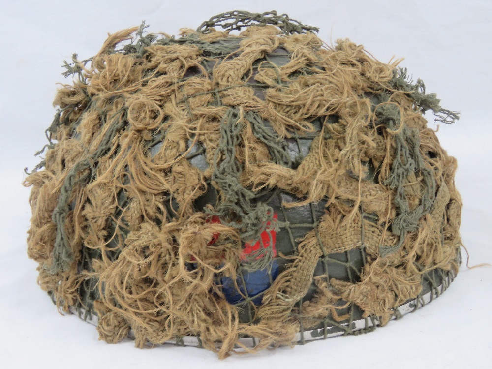 A British Paratroopers helmet with scrim