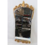 A bevel edge waisted hanging wall mirror