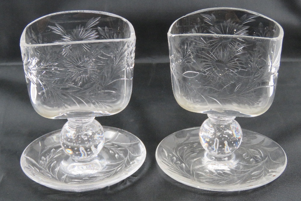 A pair of unusual clear glass waifer hol