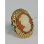 A large cameo ring having central oval carved shell female portrait,