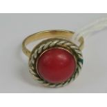 A red agate cabachon ring having rope twist border and yellow metal setting, no apparent hallmarks,